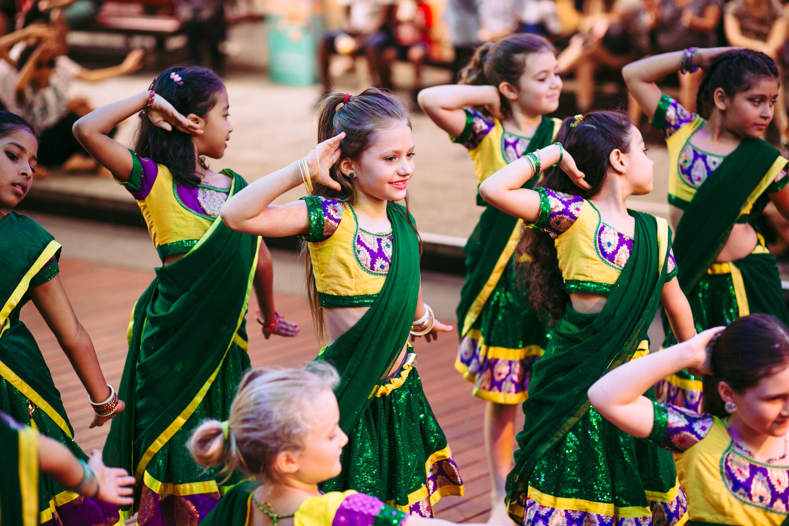 Mini Masalas - Group of children dancers wearing green saris and performing